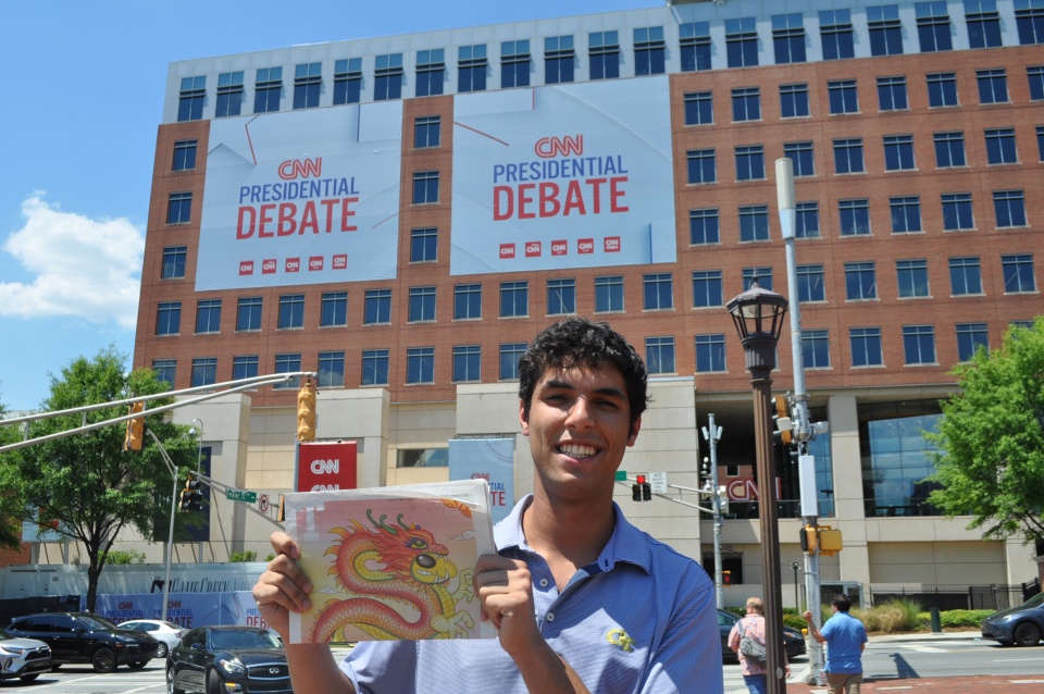 Alec Grosswald holds up a copy of the 'Technique' outside the Warner Media campus prior to the 2024 presidential debate. 