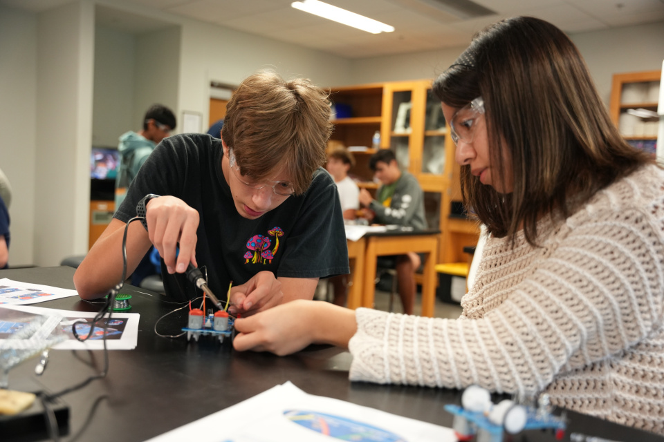 Two young leaners in a robotic lab.
