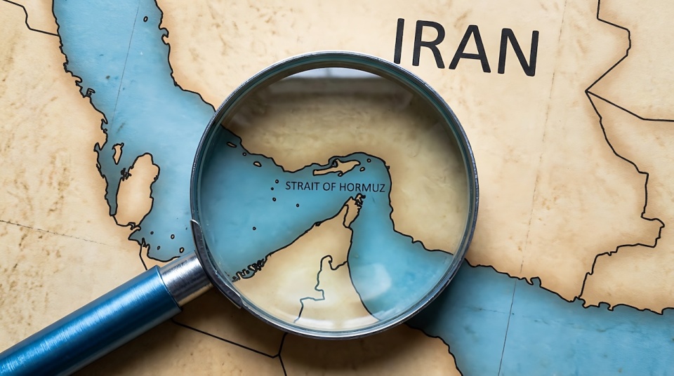 Image of a map of Iran, with a magnifying glass over the Strait of Hormuz