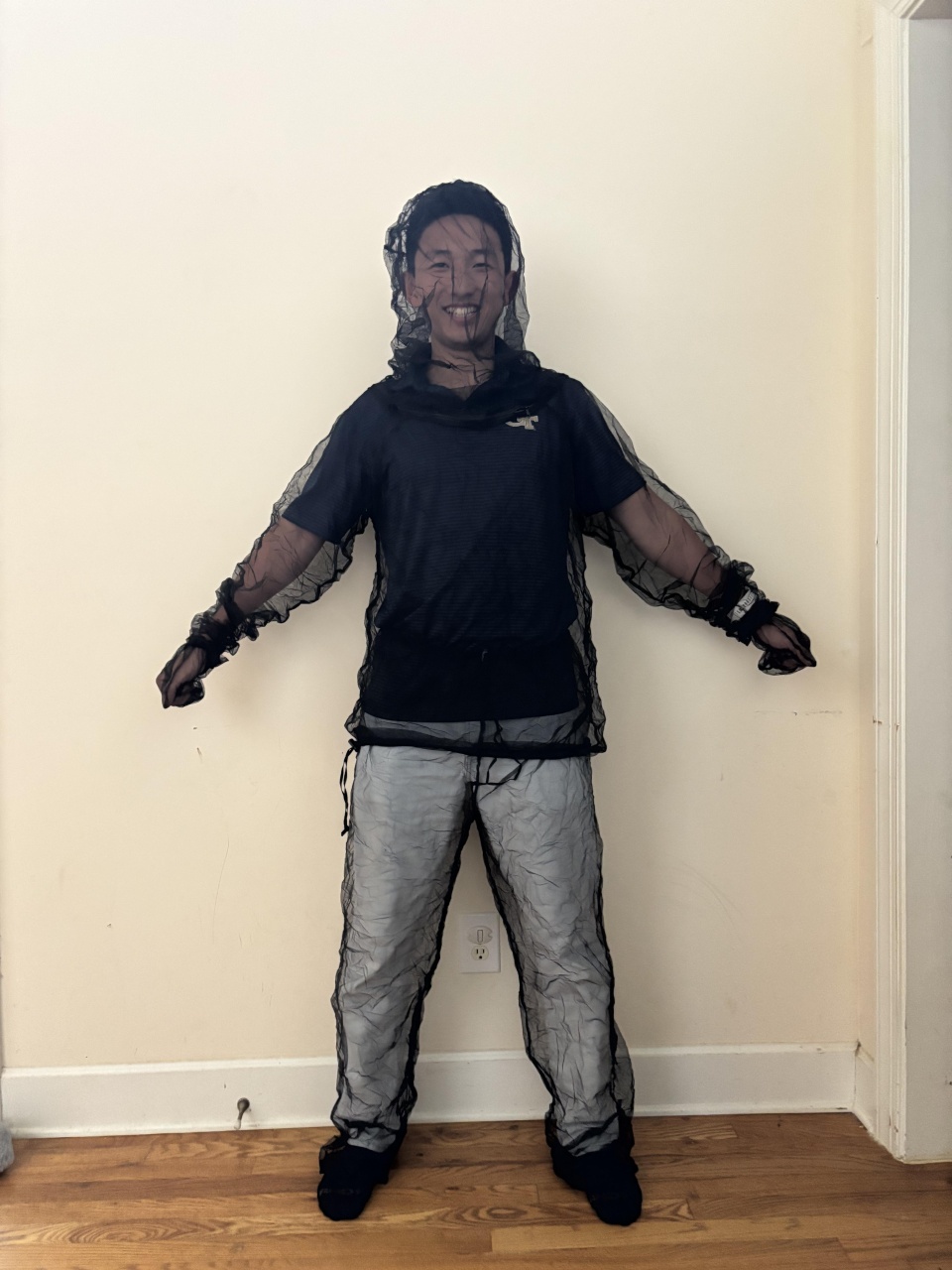 image of Chris Zuo in a mesh mosquito suit