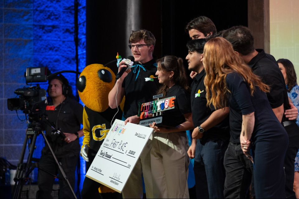 Team Hearo hold their prize after winning first place at the 2026 InVenture Prize competition.