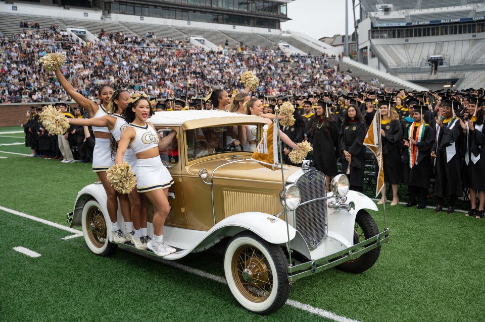 Cheerleaders on the Ramblin Wreck at Georgia Tech commencement ceremony at Bobby Dodd stadium. 